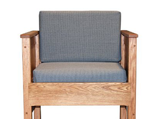 An wooden MRI waiting room chair with gray fabric cushions.