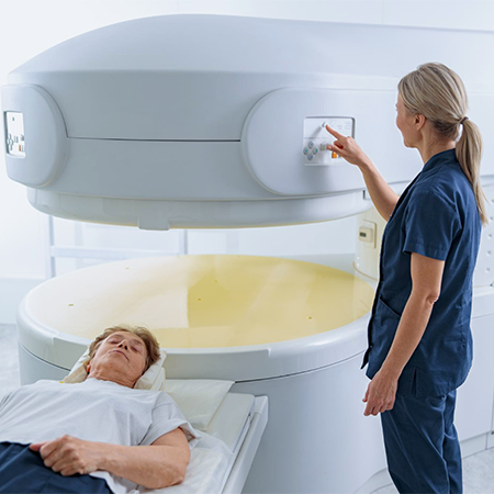 A patient is laying on a scan table for an open MRI scan. 